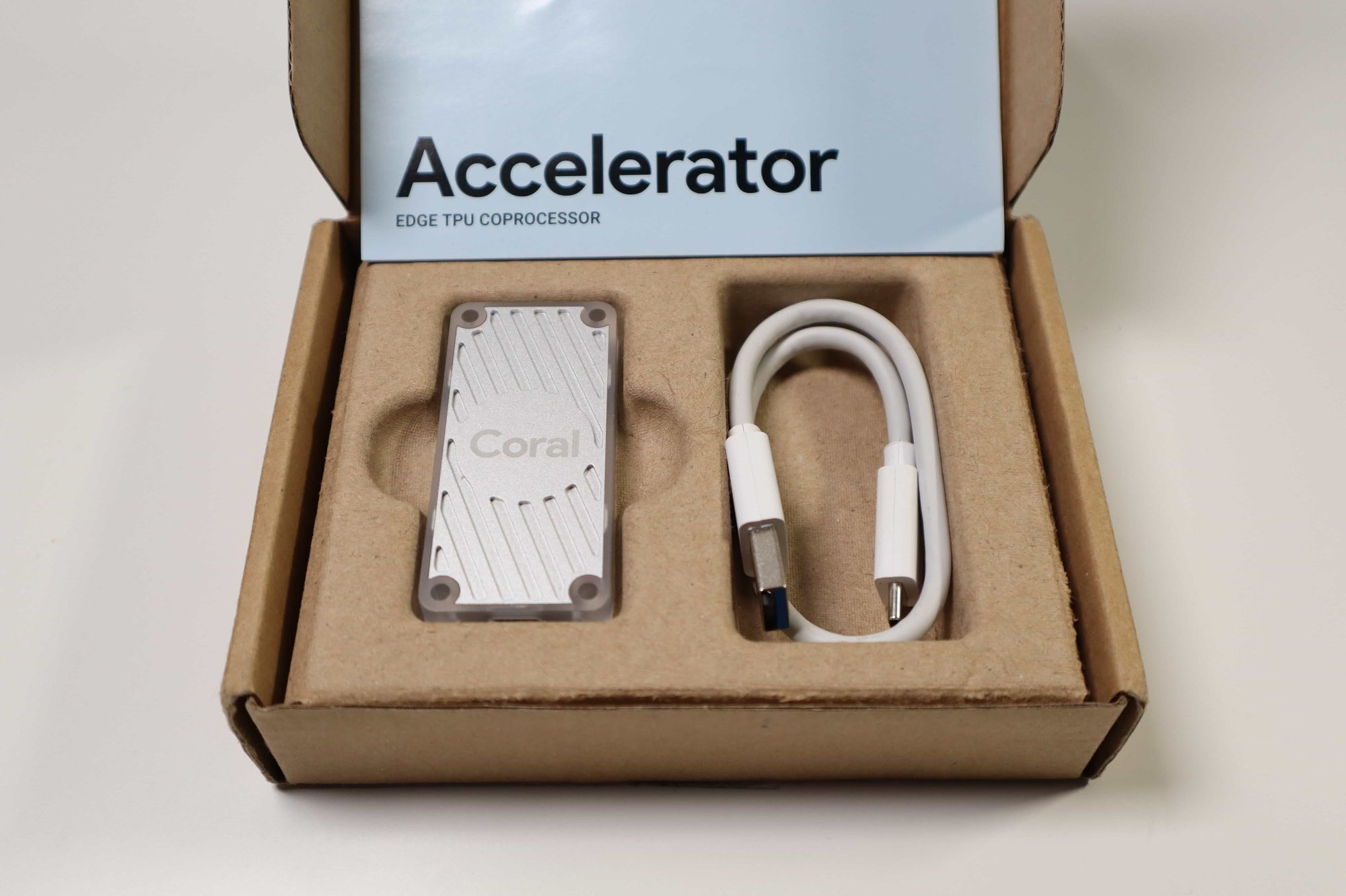 Box contains the USB Accelerator, USB Type-C to USB 3 Adapter and a simple getting started instruction